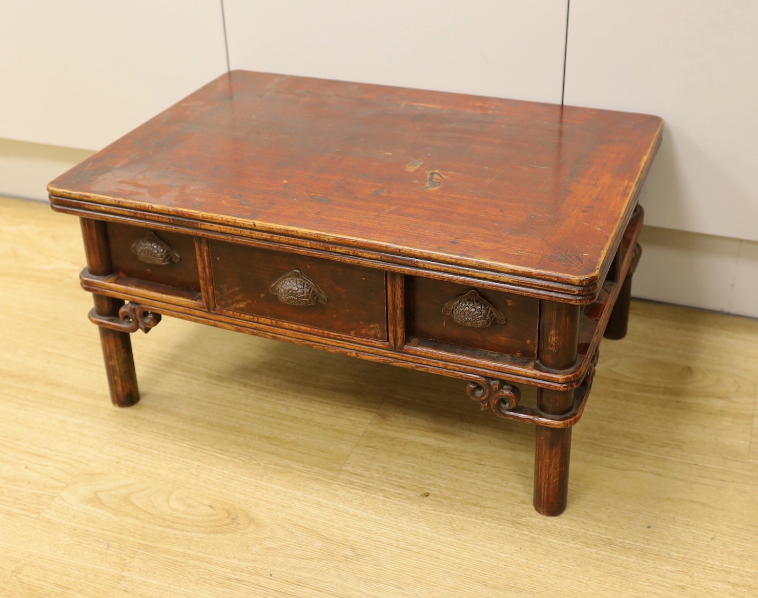 A Chinese elm and bamboo low table, fitted with three freezer drawers 63cms wide x 44cms deep x 32cms high